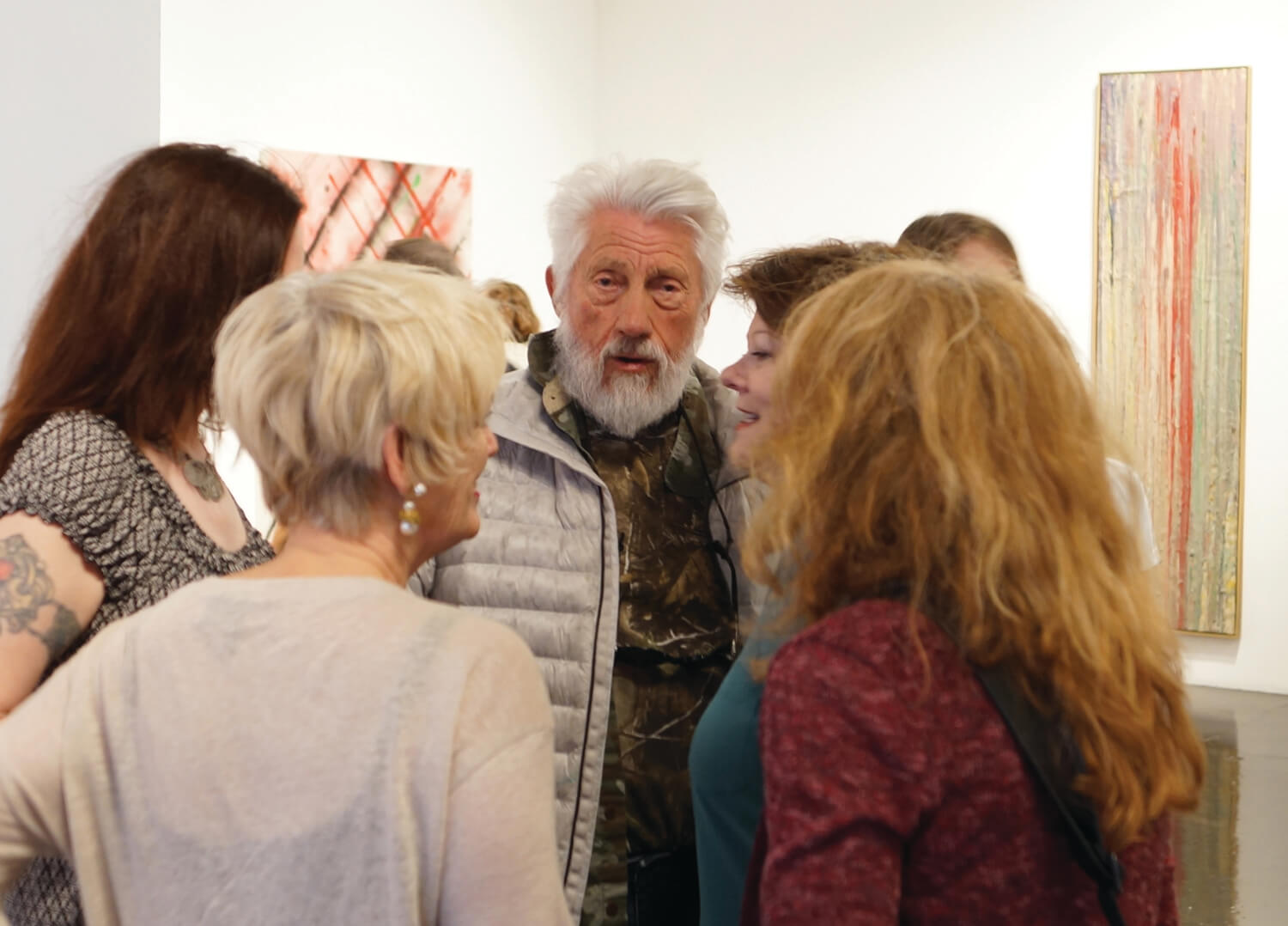 Ed Moses at his art opening at William Turner gallery, surrounded by admirers.
